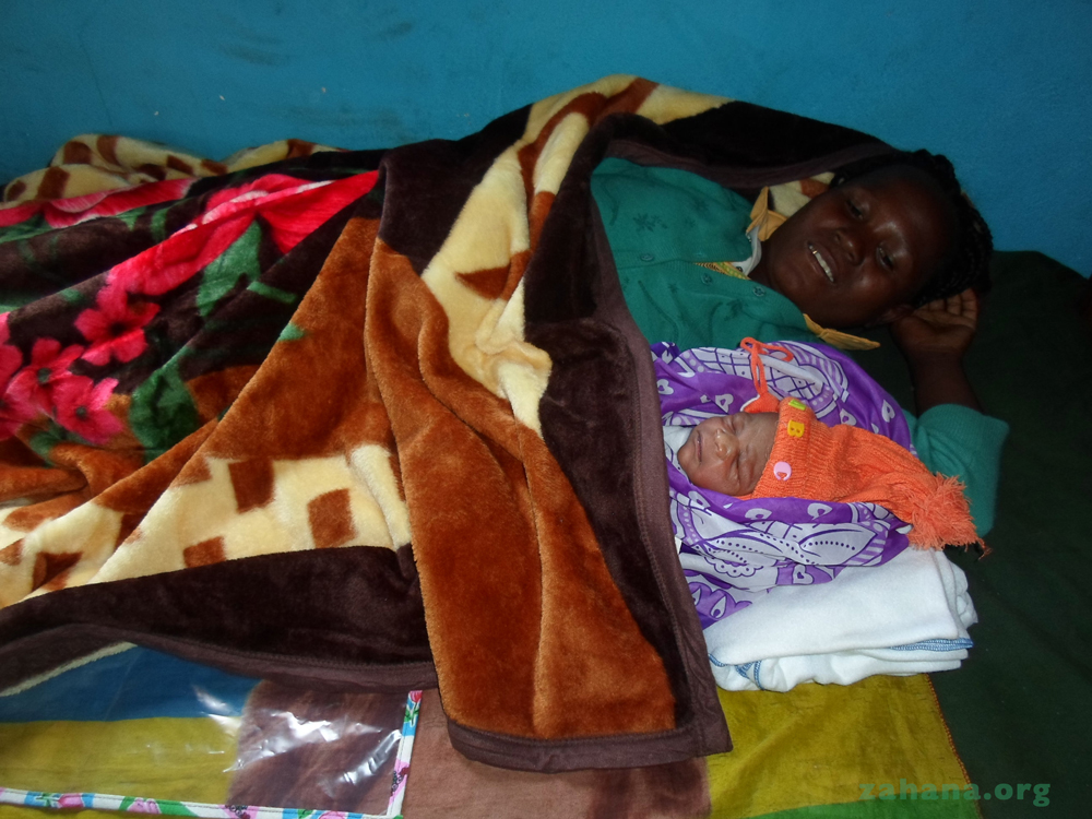 Mother and newborn baby in the bed at a CARMMA in Madagascar