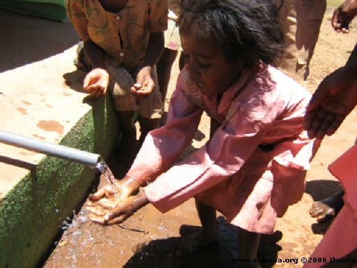 Kinds enjoying the water running in the village