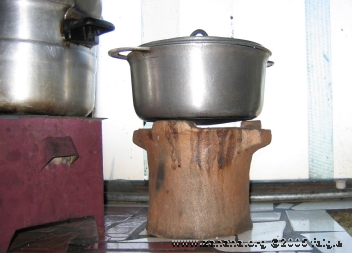 cookig rice on a charcoal stove in kitchen in Antananarivo